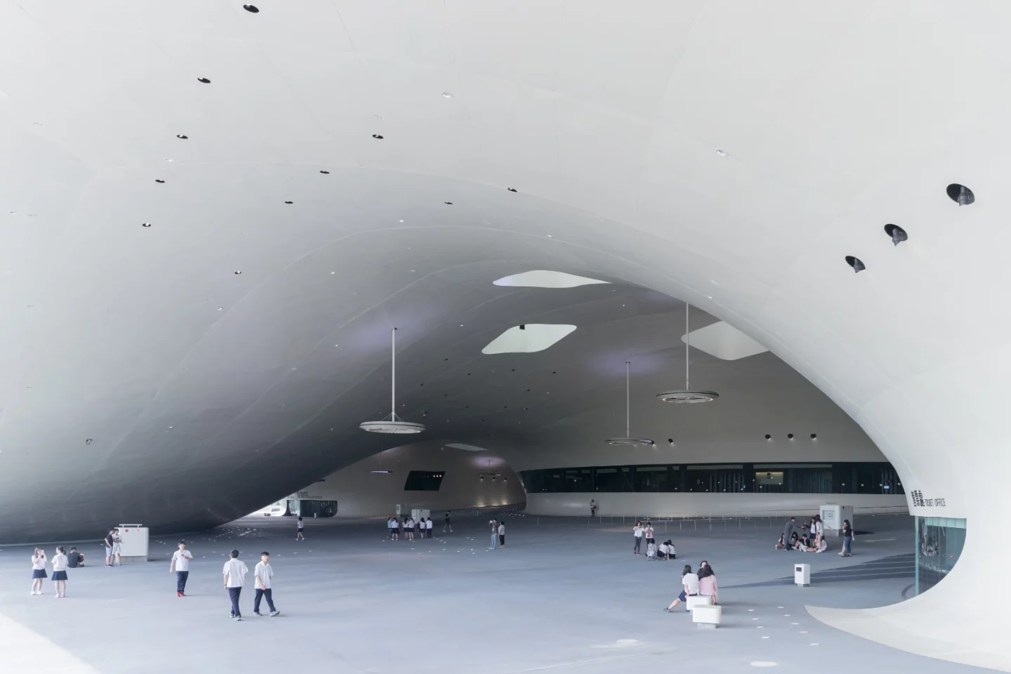 The National Kaohsiung Centre for the Arts in Taiwan houses a huge public plaza under its undulating roof