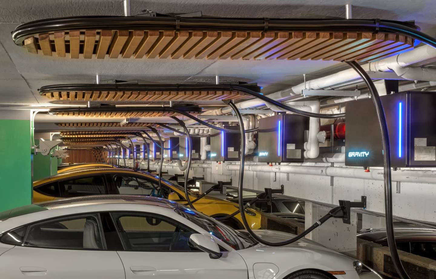 By integrating its 500-kW charger hardware into the upper wall and ceiling, Gravity avoided any reconstruction or taking up of valuable ground space
