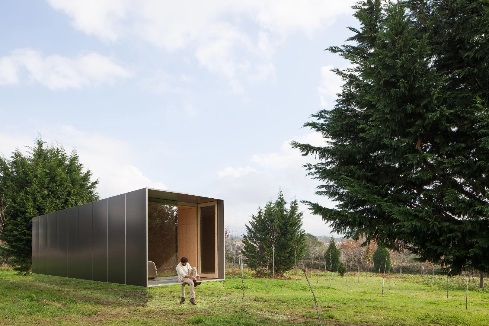 Portuguese prefabricated housing firm Mima Housing's Mima Light features a mirrored base section that makes it appear to float in mid-air