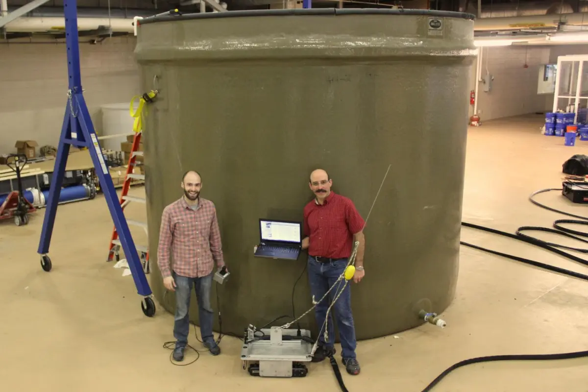 Paul Panetta (right) and colleague Dale McElhone with the Acoustic Slick Thickness ROV, in front of a testing tank (Photo: VIMS)