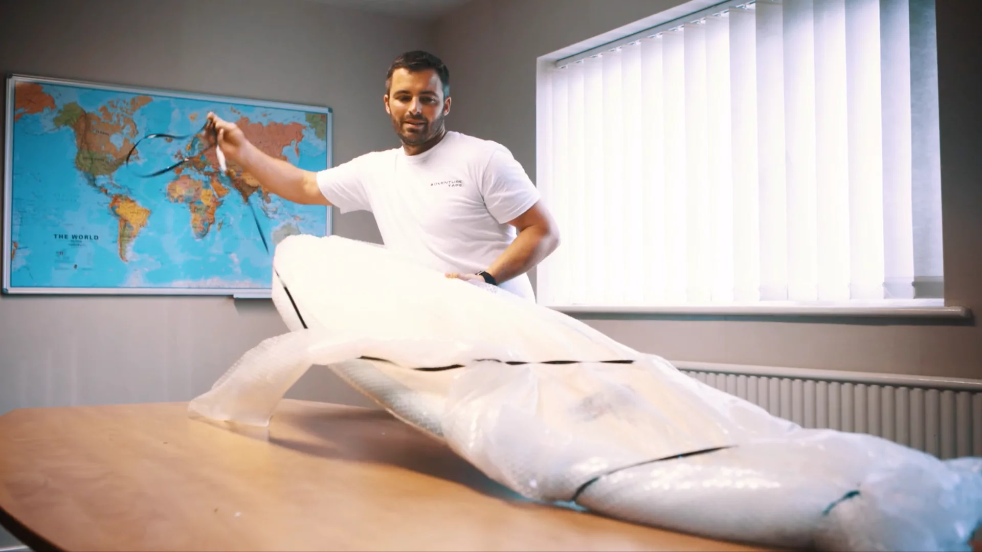 Adventure Tape wraps up a surfboard for shipping
