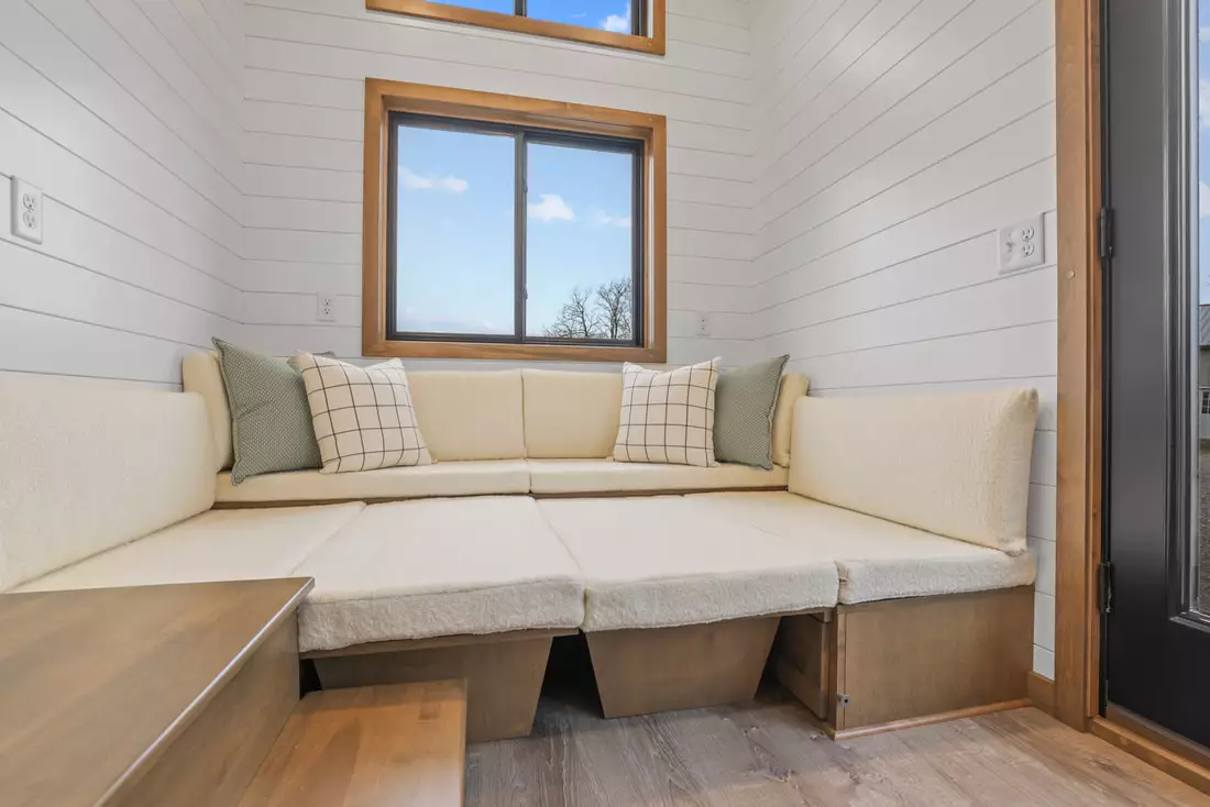 The Coastal Modern's U-shaped seating area can be converted into a bed for guests