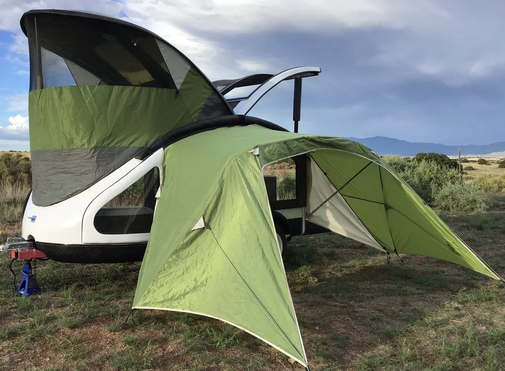 Earth Traveler teardrop with deployed front tent and side awning
