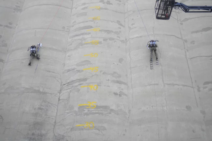 Two climbers ascend a silo, using Utah State University's PVAC system (Photo: USU)
