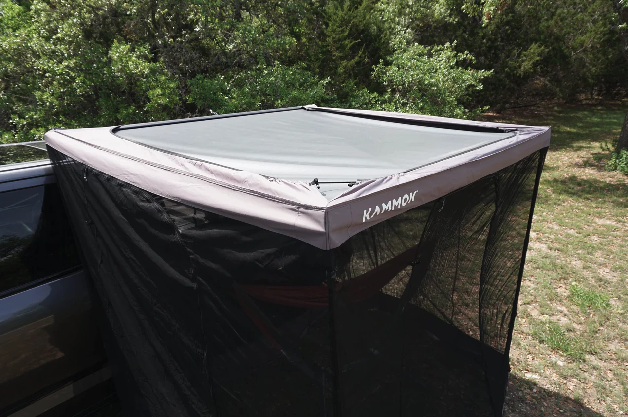 Kammok says Bug Room setup involves a one-time height adjustment to the vehicle, then a simple elastic stretch around the outside of the Crosswing awning; stakes and poles are included for windier weather