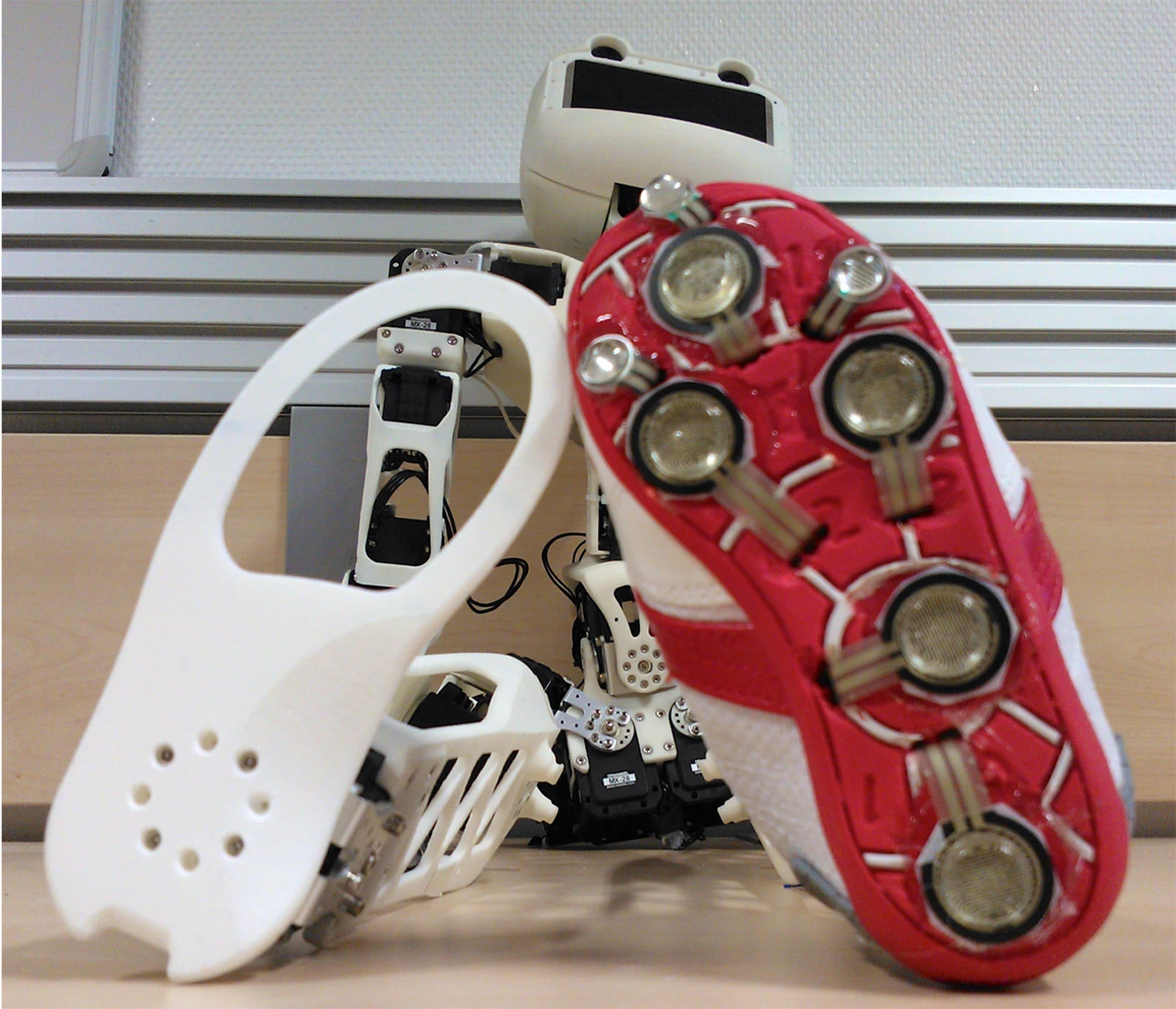 Poppy's feet are so small they fit into children's shoes, which are then covered in pressure sensors (Photo: Inria / H. Raguet)
