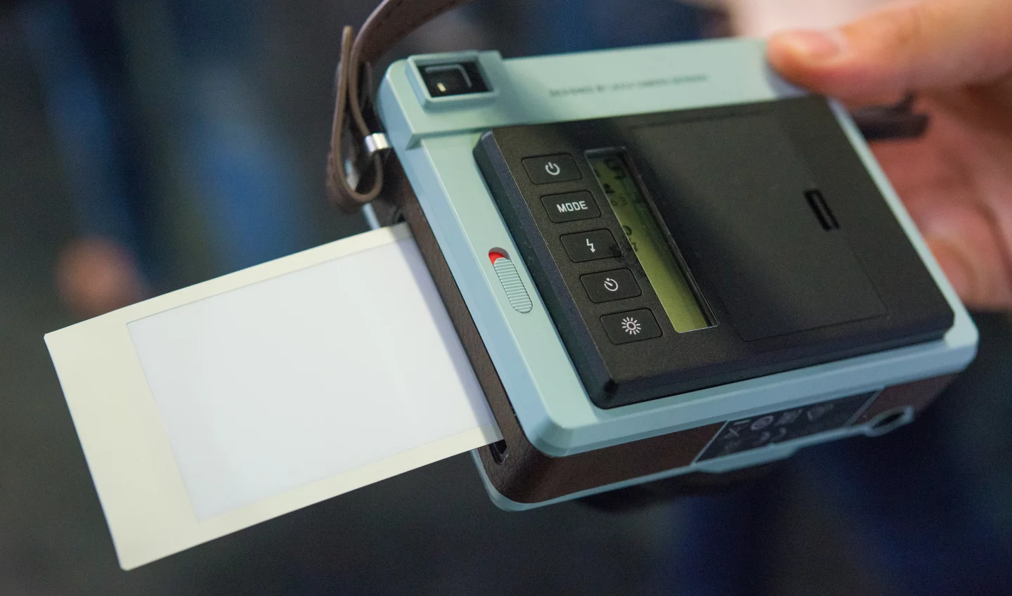 A print emerging from a Leica Sofort instant camera