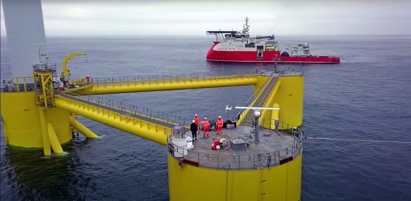 A closer look at the Windfloat Atlantic semi-submersible platform, with people for scale