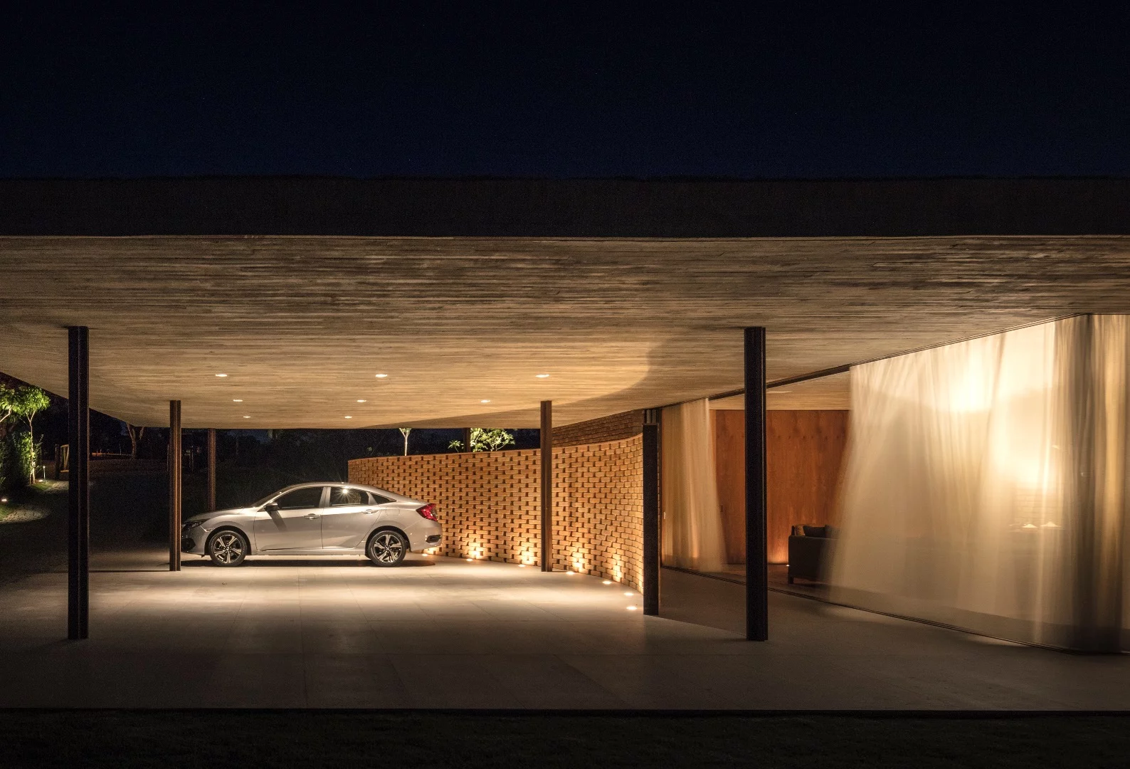 Planar House's large roof includes a covered parking area for cars