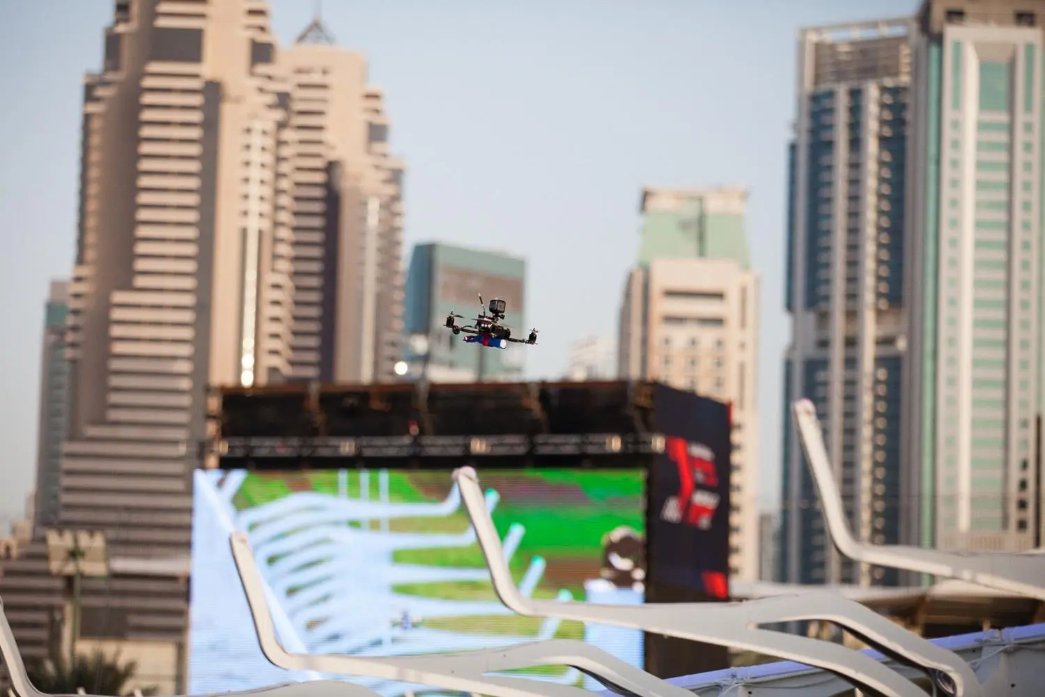 Pilots wear virtual reality headsets and steer their vehicles around the race track in first person view