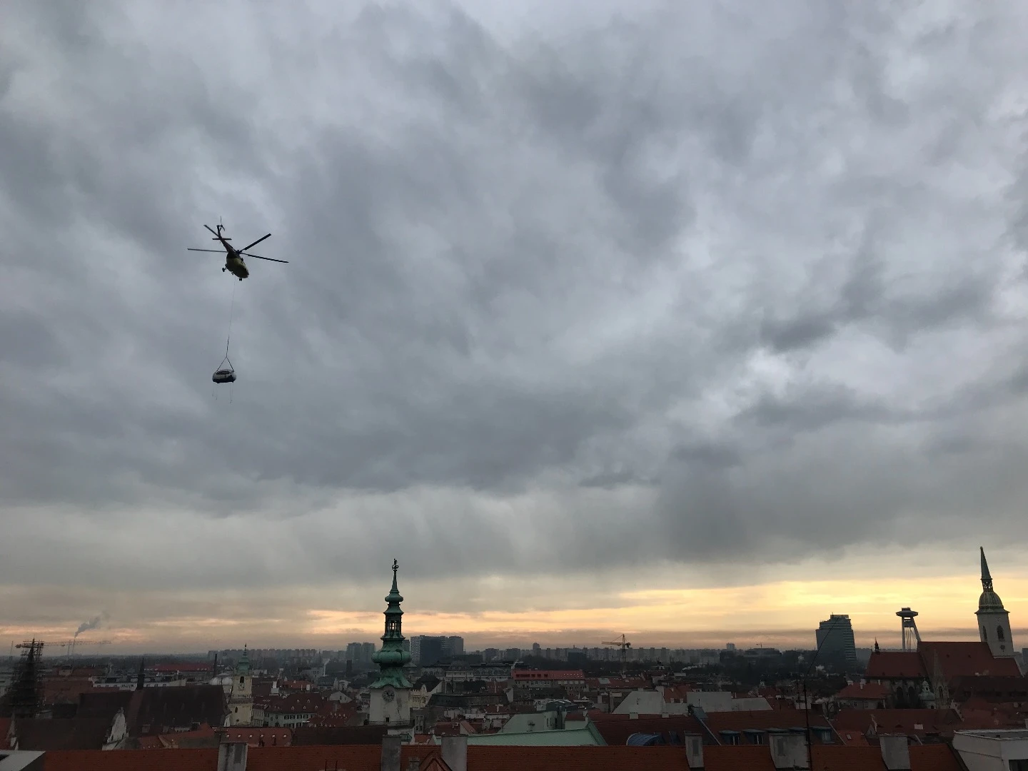 The first finished Ecocapsule being delivered on the roof of the UNIQ building in the Bratislava city center by helicopter