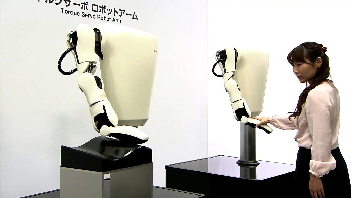 Toyota presented its new compliant robot arm at IREX 2013, which could drive the motion of a second arm