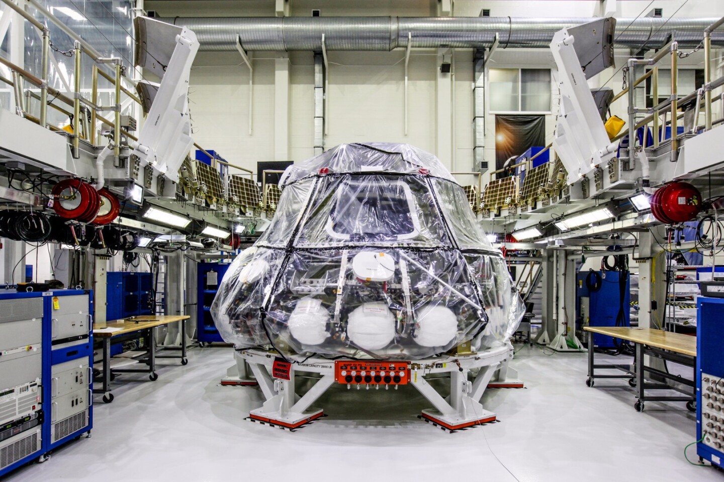 The Orion crew module for NASA’s Exploration Mission 1 (EM-1) is secured in a work station in the Neil Armstrong Operations and Checkout Building high bay at NASA’s Kennedy Space Center in Florida