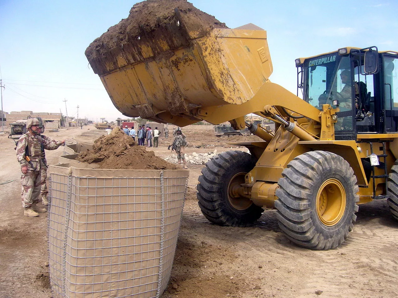 A Hesco Bastion being filled by a front loader in Iraq
