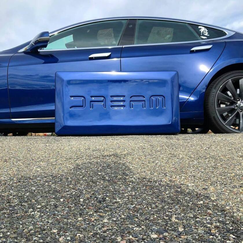 The Dreamcase wears a Tesla-like font and car-matching color