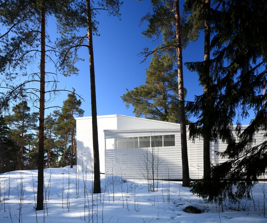 The building is nestled amidst its natural surroundings of rock beds and trees