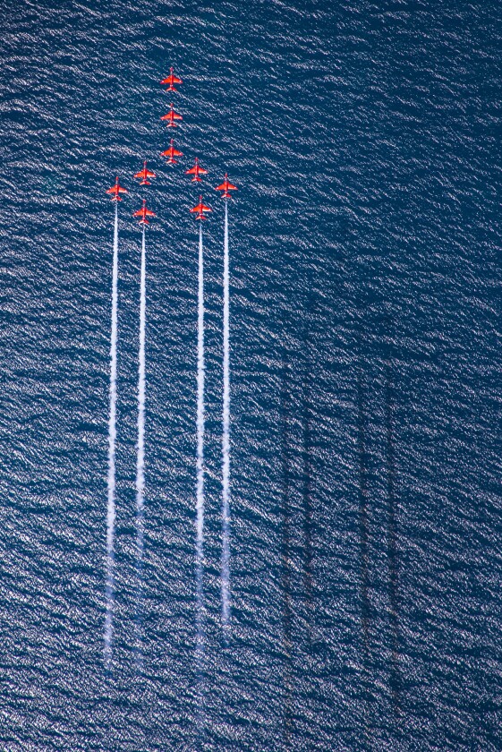 Winner of the RAF Image of the Year. The Royal Air Force Aerobatic Team, the Red Arrows perform Concorde over the deep blue sea of Greece.