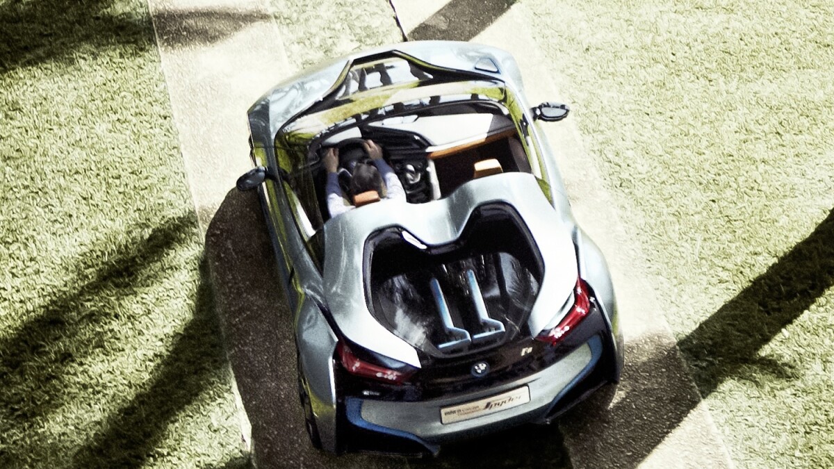 BMW's i8 Spyder with two matching BMW three-wheeled electric kick scooters in the rear