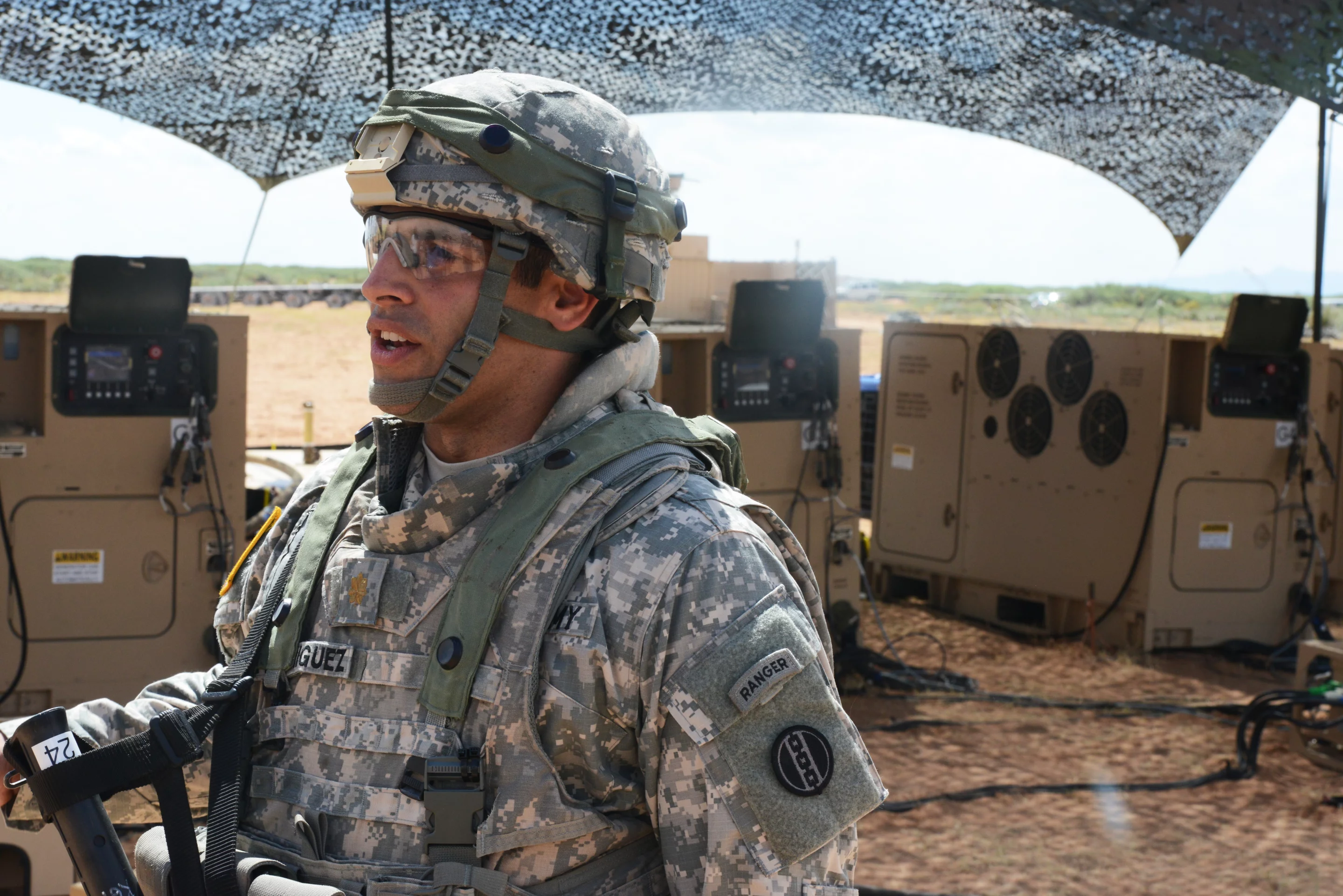 Major Daniel Rodriguez, company commander, 542nd Quartermaster Company, a Reserve unit out of Erie, Pennsylvania, points out his Advanced Medium Mobile Power Source, or amps micro grid, which controls six 60-kilowatt generators