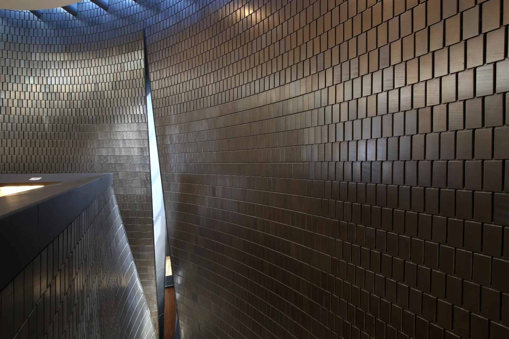 "The building is a powerful instrument that exists to emanate music and light. The walls, clad in terra cotta, rise in subtle curves that merge, part, and intertwine, modeled by light, gravity, and acoustics."