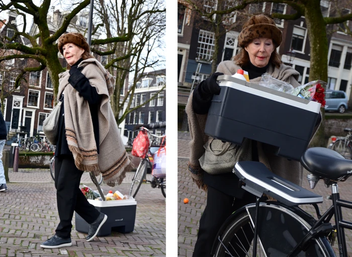 The Crate features suitcase-like wheels and a telescoping handle, allowing users to pull it along behind them when it's off the bike