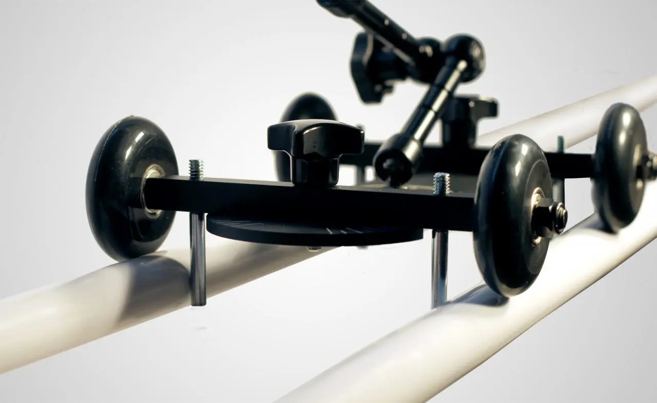 The rail kit provides two blocks with clamps and four guide rods that fit onto the bottom of the dolly to keep it steady