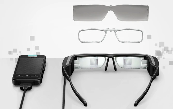 The BT-200 smart glasses come supplied with a prescription lens insert, two removable shades, some earbuds and a handheld control unit