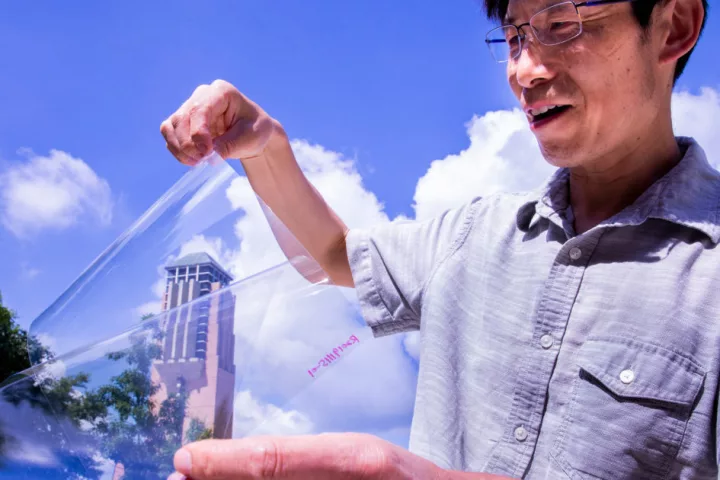 Lead researcher Jay Guo with the transparent, conductive plastic
