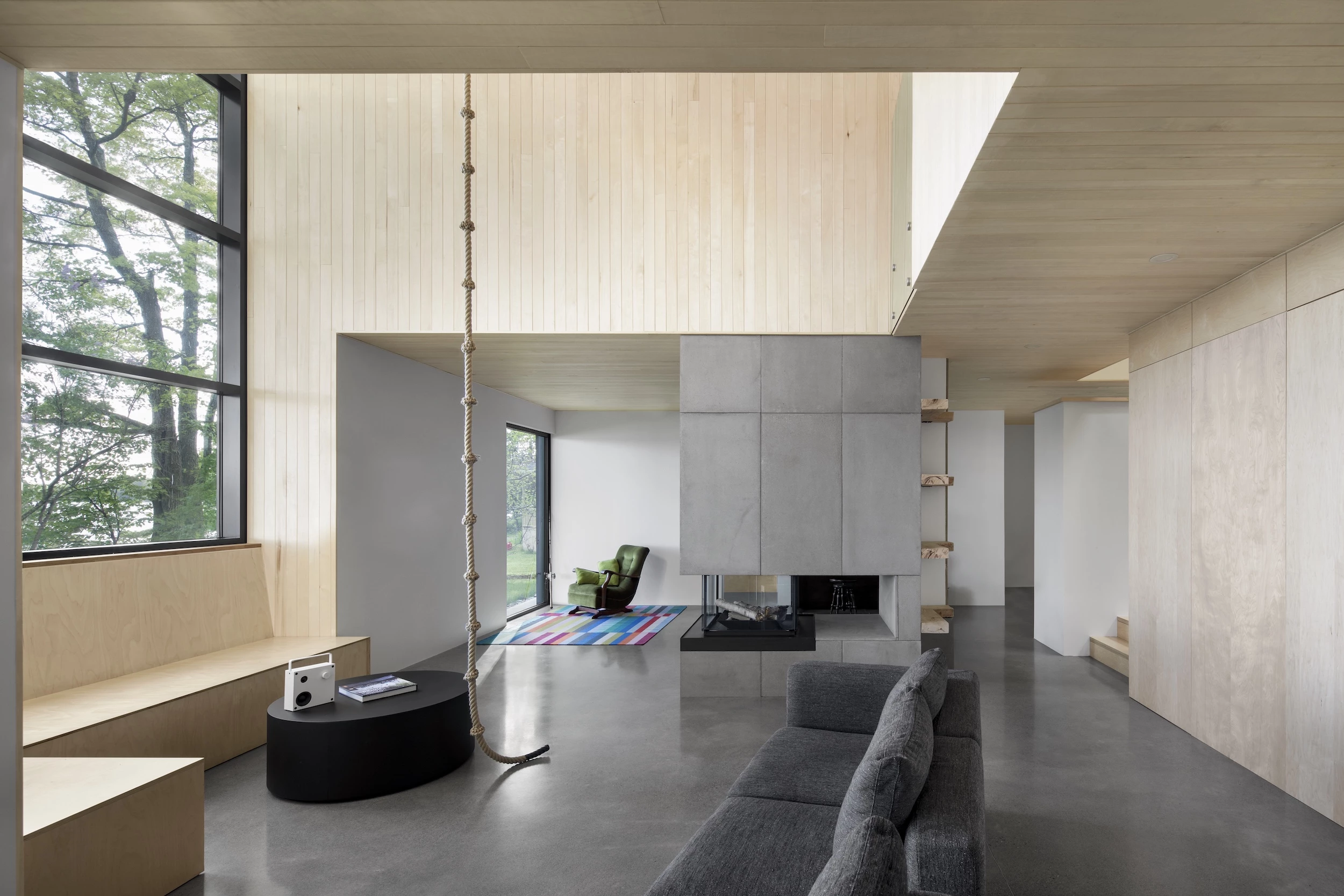 The Lakeside Cabin's material palette is a simple mix of concrete, wood, and expansive glazing