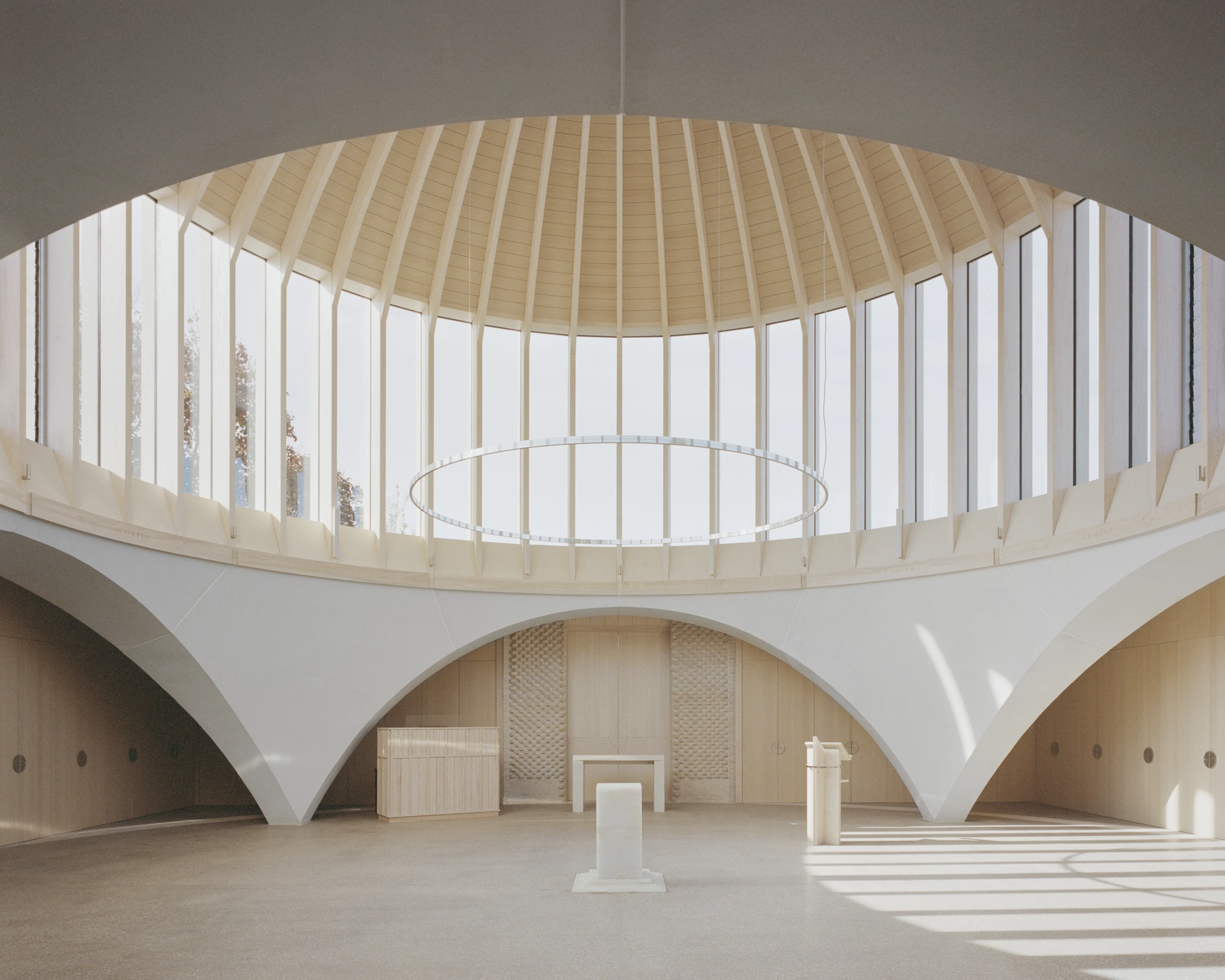 New Temple Complex was designed by James Gorst Architects and is located in England's South Downs National Park. It includes a temple, library, chapels, meeting spaces, and more