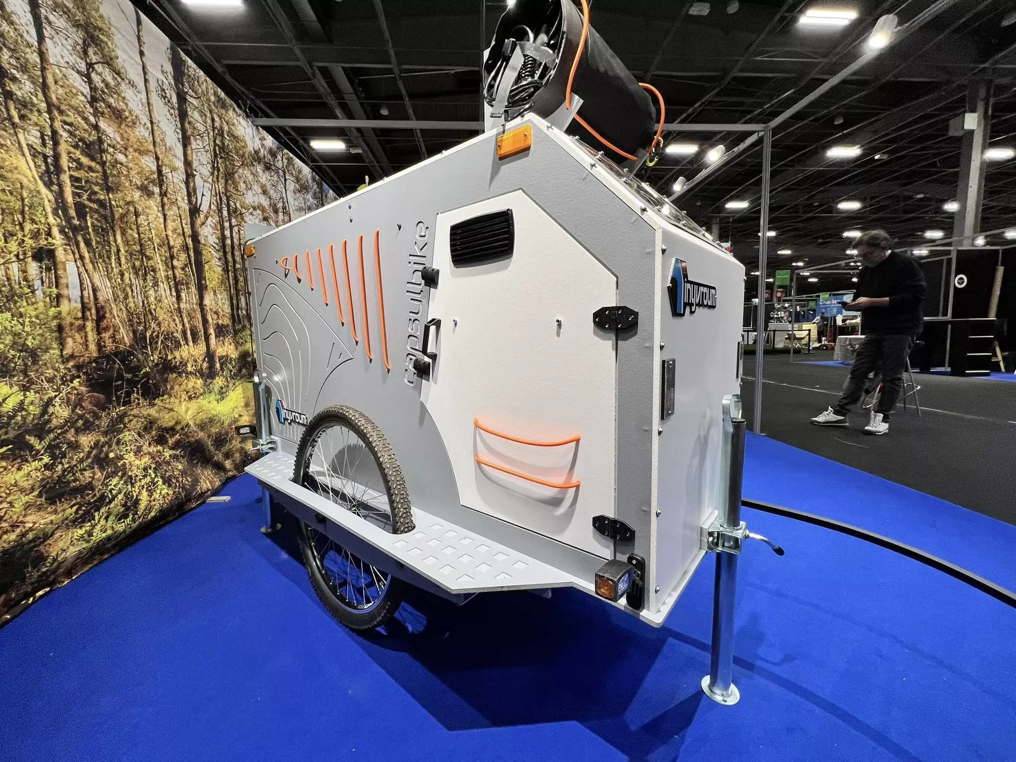 The CapsulBike trailer has a solar shower on the roof and a pop-up shower/bathroom tent