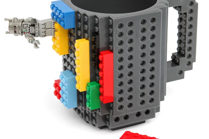 The Build-On Brick Mug is a coffee cup covered in studs and holes for attaching Lego and other building blocks to customize it
