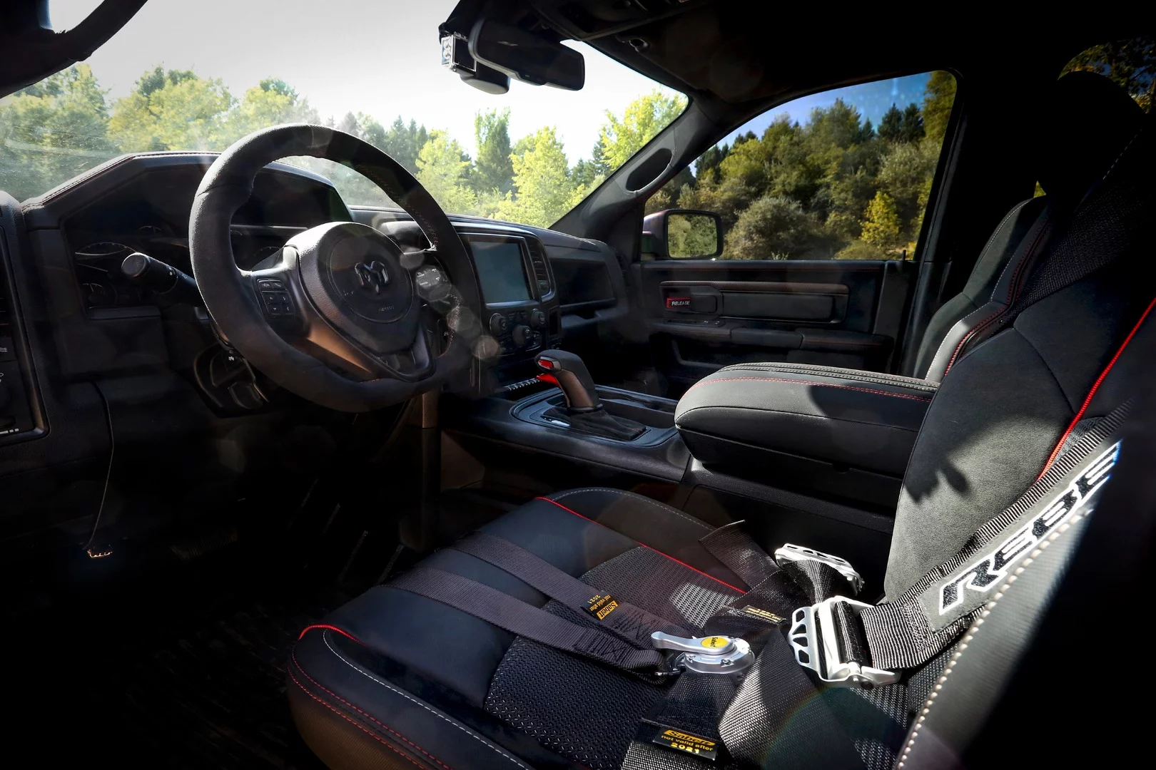 The Ram Rebel TRX interior includes six-point harnesses and suede trim