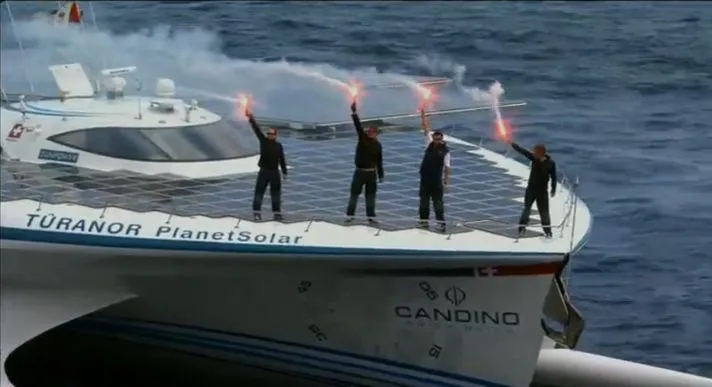 Crew members on the deck of the TURANOR PlanetSolar, as it enters Monaco's Hercule Harbor