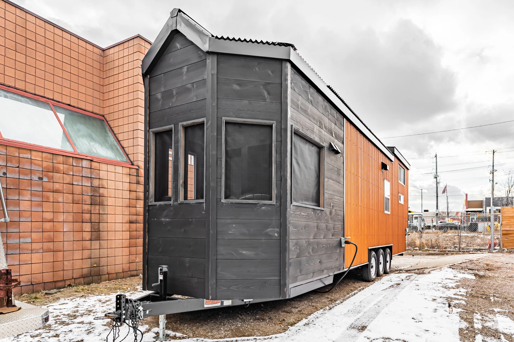 The Sherloak Homes is based on a triple-axle trailer and finished in steel and Shou Sugi Ban-treated wood
