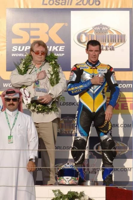 Alstare Suzuki Corona Extra team manager Francis Batta on the rostrum with Corser after leg two