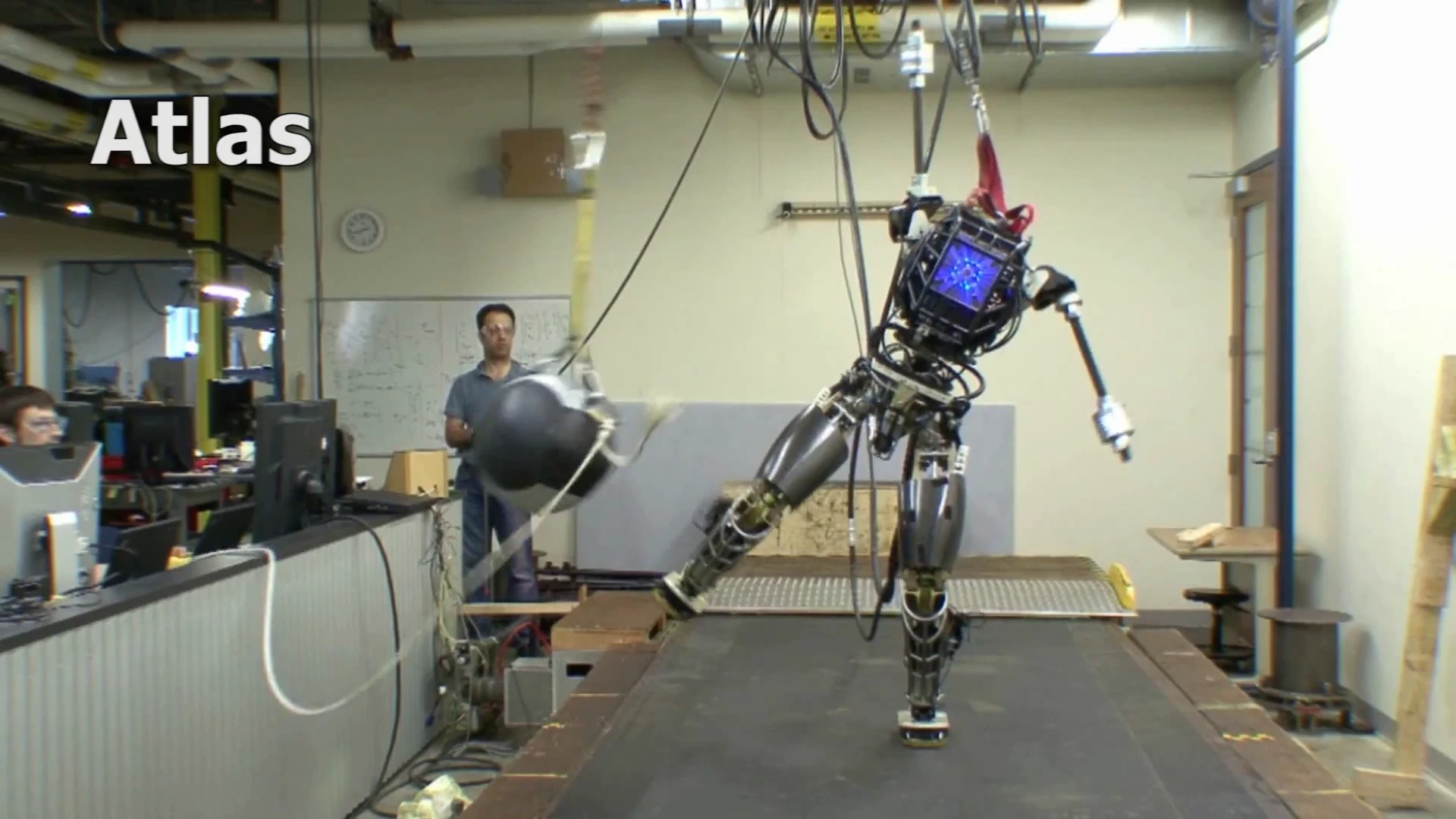 An incomplete version of the ATLAS robot maintains its balance even when hit with a 20 lb ball