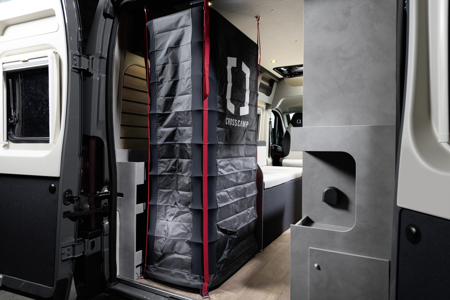 No mention of a toilet, but the Crosscamp Flex 541 does offer a quick-deploying shower that gets out of the way when not in use