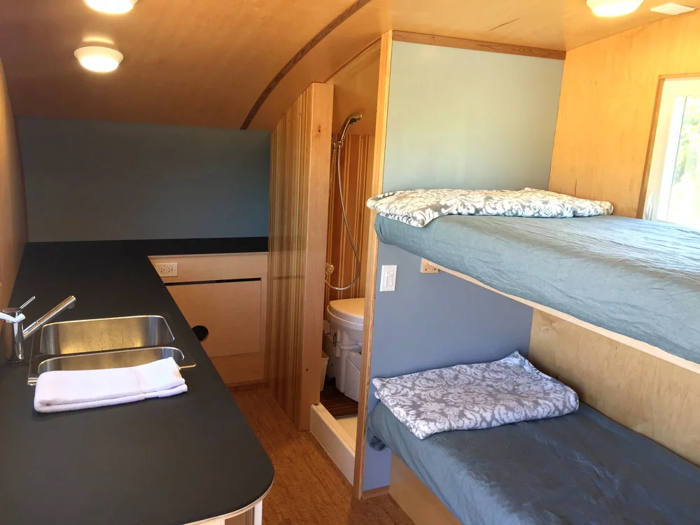 The Timberline's kitchenette includes a relatively large counter space and a sink, under-counter fridge, and two-burner induction stove