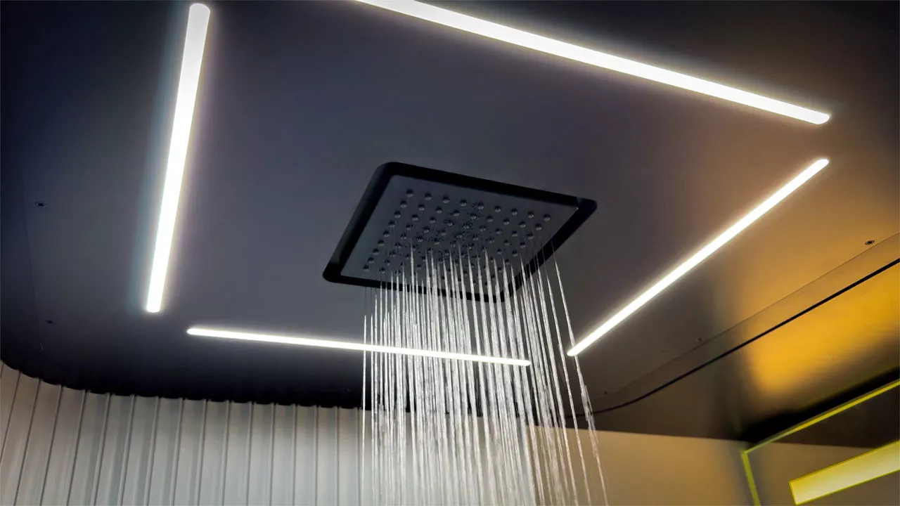 The rainfall shower is located right over the center aisle, which becomes part of the bathroom