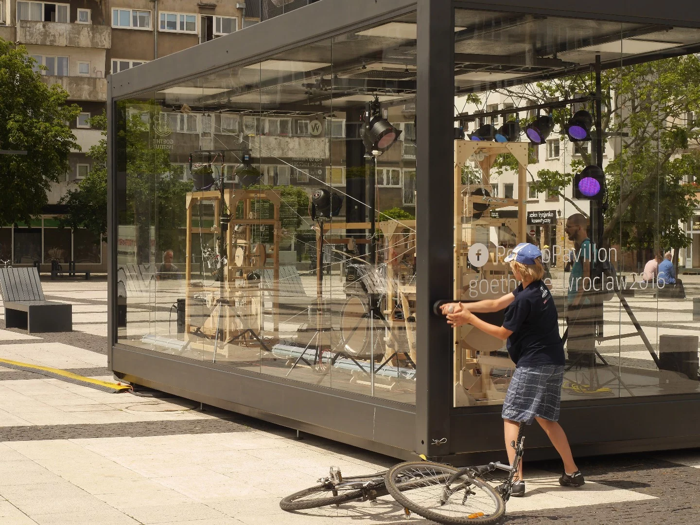 The musical cacophony is activated by a huge hand crank to the right of the transparent glass case