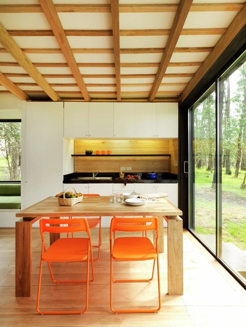 The open plan living room adjoins a European wall kitchen and dining area
