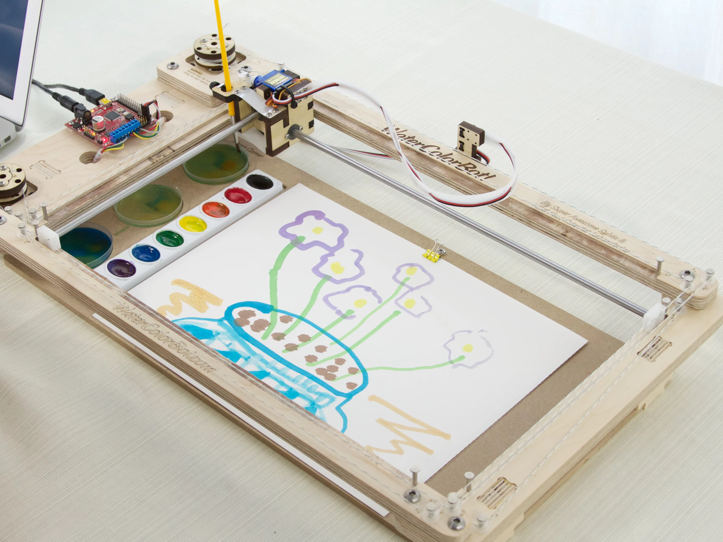 The WaterColorBot doesn't require any pricey or hard-to-find materials to paint, just a set of standard watercolors, a small paintbrush, and a sheet of paper