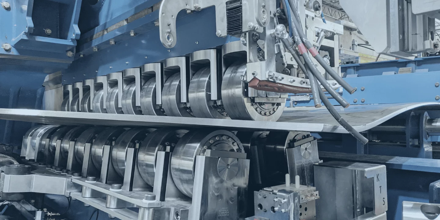 Roller systems bend the sheet or coil steel into shape
