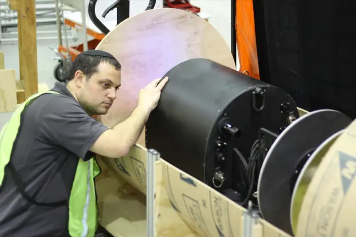 David Kohanbash, senior research programmer, tests the RadPiper robot in a processing pipe mock-up