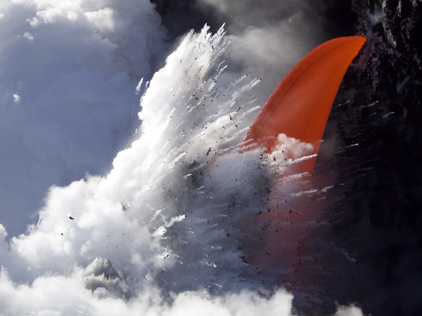 Fluid lava exploding in the sea at the Puna District in Hawaii
