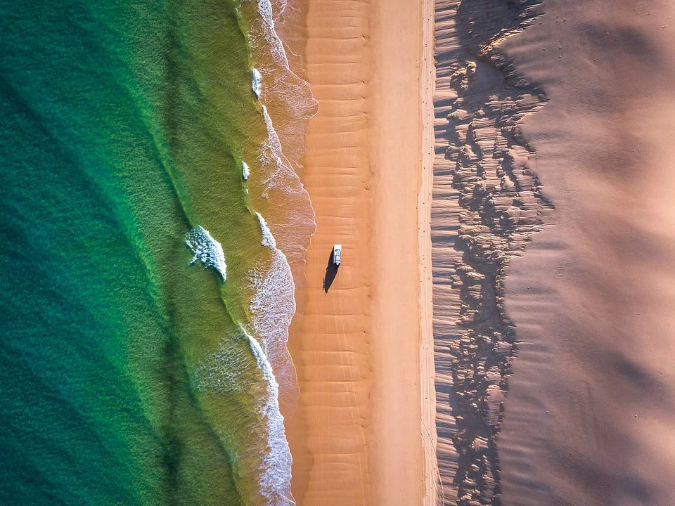 'Racing the tide to safety'. Sandy Cape Light, Australia