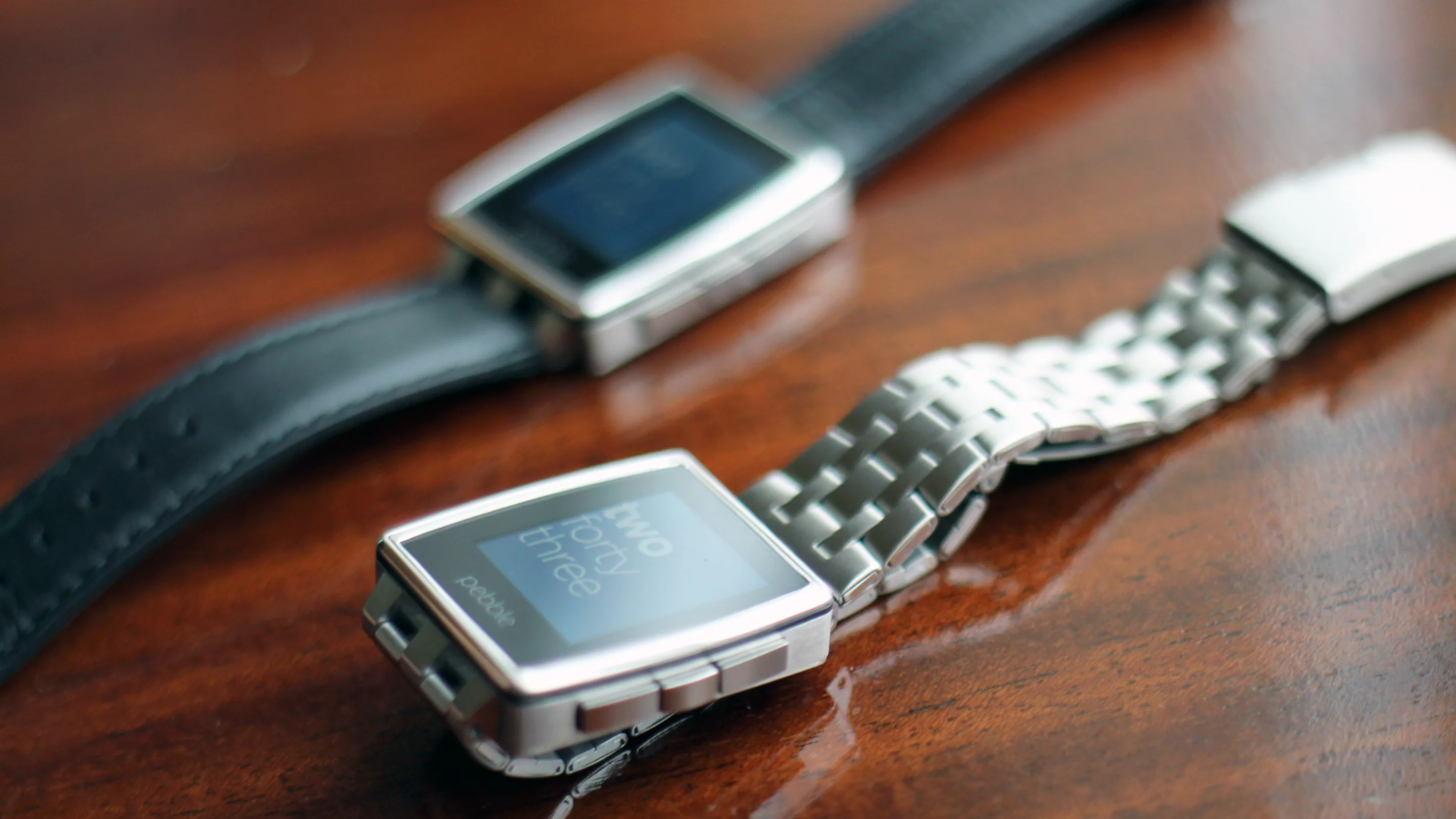 The Brushed Stainless Steel will ship with a Brushed Stainless band (foreground) as well as a black leather one (background)