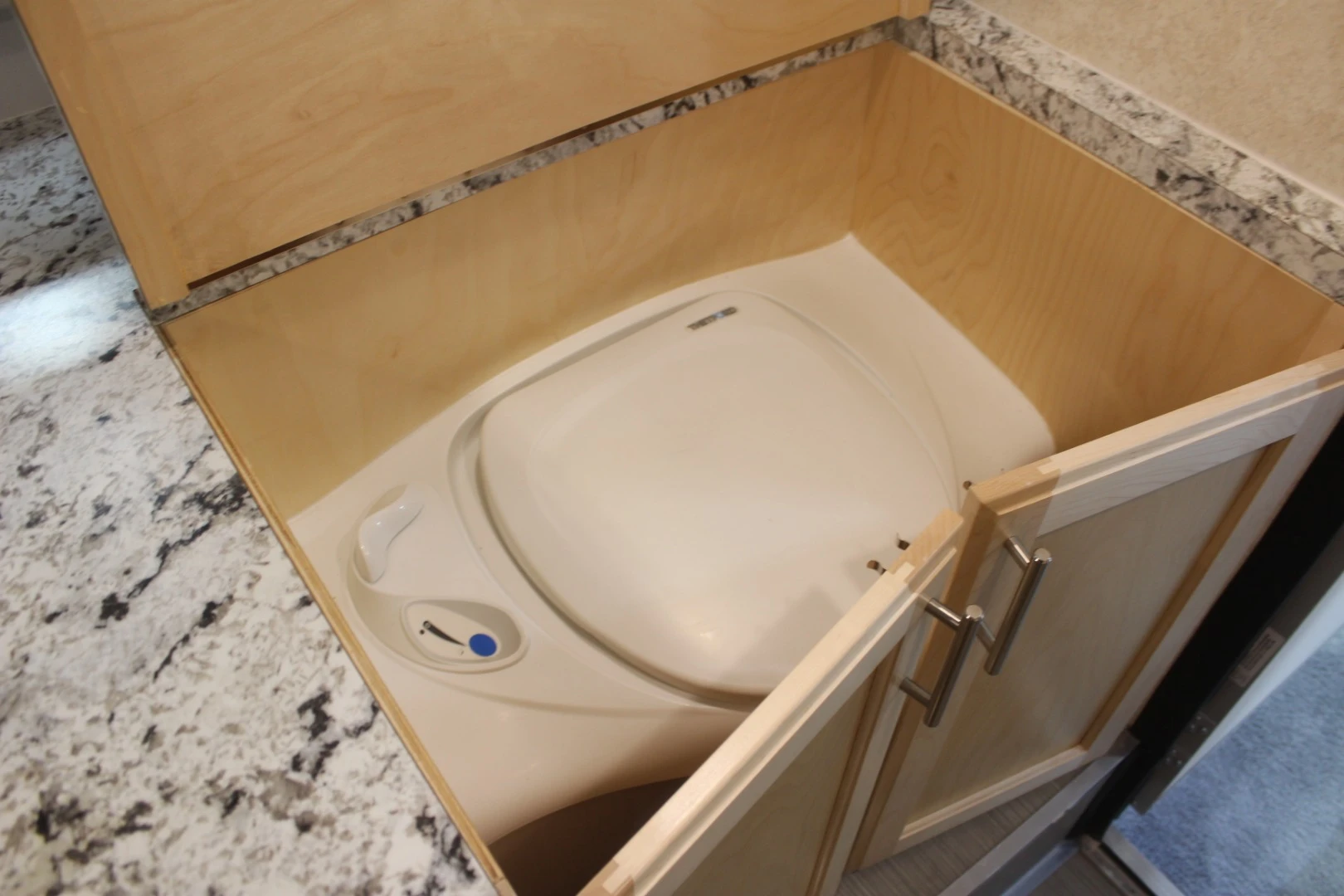 Little Guy shrinks its Max trailer line further into Micro Max size by removing the wet bath seen on the Mini Max and sliding a standalone toilet into a cabinet