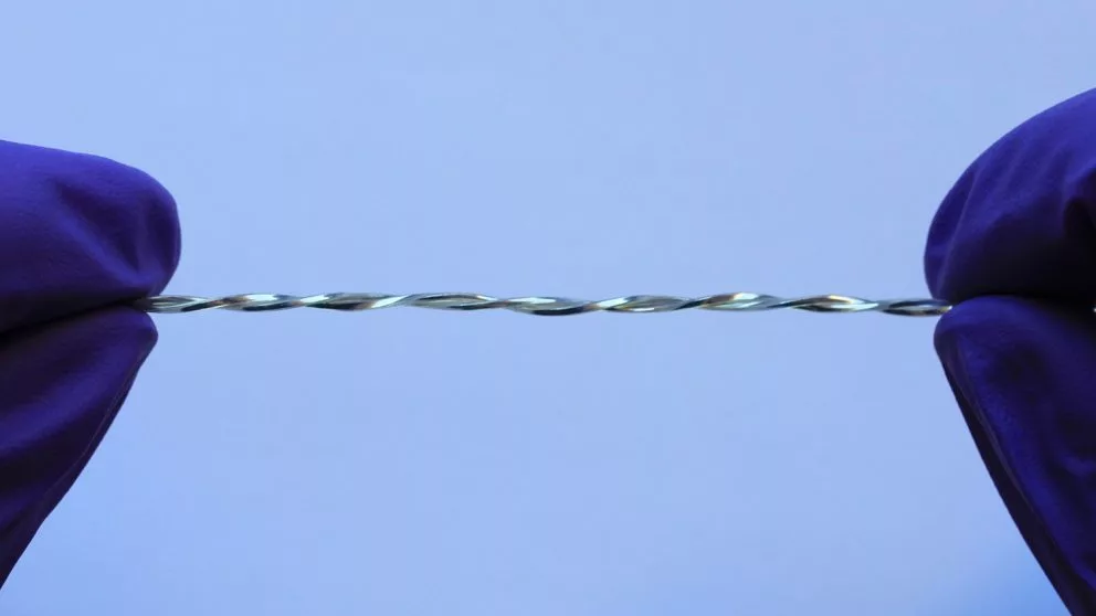 Polymer tubes filled with liquid metal are twisted together to form a conductive fiber